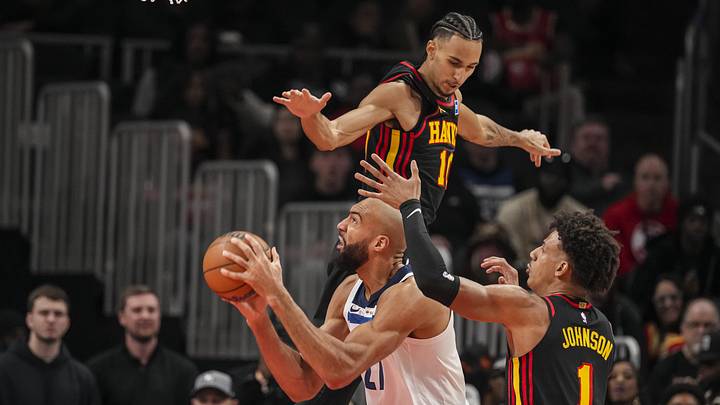 Dec 31, 2025; Atlanta, Georgia, USA; Minnesota Timberwolves center Rudy Gobert (27) tries to get to the basket between Atlanta Hawks forwards Zaccharie Risacher (10) and Jalen Johnson (1) during the first half at State Farm Arena. Mandatory Credit: Dale Zanine-Imagn Images Dec 31, 2025; Atlanta, Georgia, USA; Minnesota Timberwolves center Rudy Gobert (27) tries to get to the basket between Atlanta Hawks forwards Zaccharie Risacher (10) and Jalen Johnson (1) during the first half at State Farm Arena. Mandatory Credit: Dale Zanine-Imagn Images