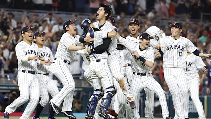 Mar 21, 2023; Miami, Florida, USA;  Japan designated hitter and closing pitcher Shohei Ohtani (16) and Japan catcher Yuhei Nakamura (27) and team Japan celebrate defeating the USA in the World Baseball Classic at LoanDepot Park. Mandatory Credit: Rhona Wise-Imagn Images