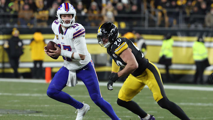 Buffalo Bills quarterback Josh Allen looks to pass as Pittsburgh Steelers linebacker T.J. Watt pursues.