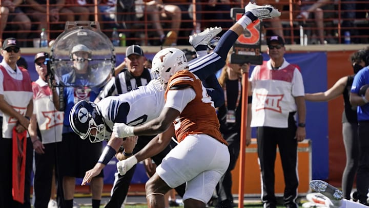 Oct 28, 2023; Austin, Texas, USA; Brigham Young quarterback Kedon Slovis (10) leaps after keeping the ball for yards during the first half against the Texas Longhorns at Darrell K Royal-Texas Memorial Stadium. Mandatory Credit: Scott Wachter-Imagn Images