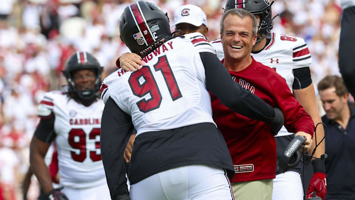 Oct 19, 2024; Norman, Oklahoma, USA;  South Carolina Gamecocks defensive tackle Tonka Hemingway (91) celebrates with South Carolina Gamecocks head coach Shane Beamer after returning a fumble for a touchdown during the first half against the Oklahoma Sooners at Gaylord Family-Oklahoma Memorial Stadium. Mandatory Credit: Kevin Jairaj-Imagn Images