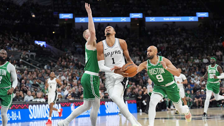 Mar 10, 2026; San Antonio, Texas, USA; San Antonio Spurs forward Victor Wembanyama (1) drives to the basket against Boston Celtics forward Sam Hauser (30) and guard Derrick White (9) in the first half at Frost Bank Center. Mandatory Credit: Daniel Dunn-Imagn Images