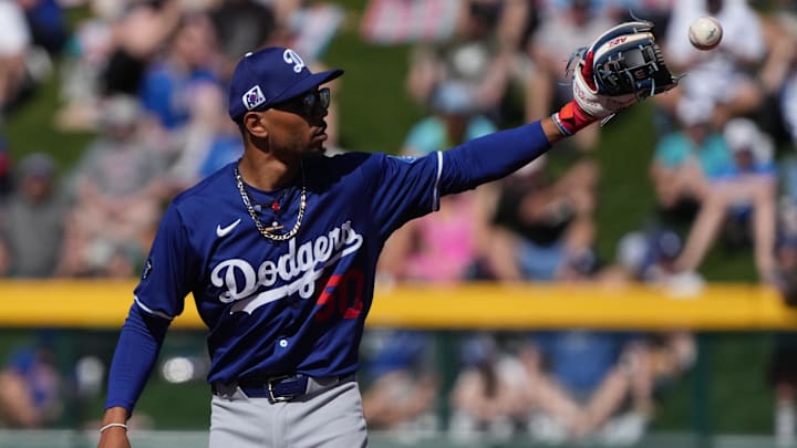 Feb 21, 2025; Mesa, Arizona, USA; Los Angeles Dodgers shortstop Mookie Betts (50) directs the outfielders during the first inning against the Chicago Cubs at Sloan Park.