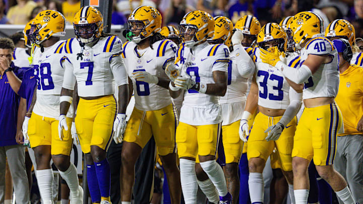 Oct 11, 2025; Baton Rouge, Louisiana, USA;  LSU Tigers linebacker Harold Perkins Jr. (7), linebacker Whit Weeks (40) and linebacker West Weeks (33) walk on the field against the South Carolina Gamecocks during the first half at Tiger Stadium. Mandatory Credit: Stephen Lew-Imagn Images