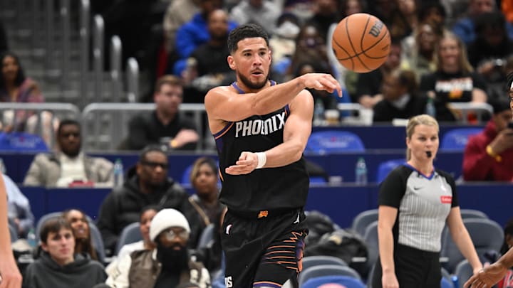 Dec 29, 2025; Washington, District of Columbia, USA;  Phoenix Suns guard Devin Booker (1) passes the ball against the Washington Wizards during the third quarter at Capital One Arena. Mandatory Credit: Rafael Suanes-Imagn Images