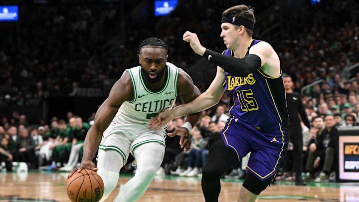 Mar 8, 2025; Boston, Massachusetts, USA; Boston Celtics guard Jaylen Brown (7) drives to the basket against Los Angeles Lakers guard Austin Reaves (15) during the fourth quarter at the TD Garden. Mandatory Credit: Brian Fluharty-Imagn Images