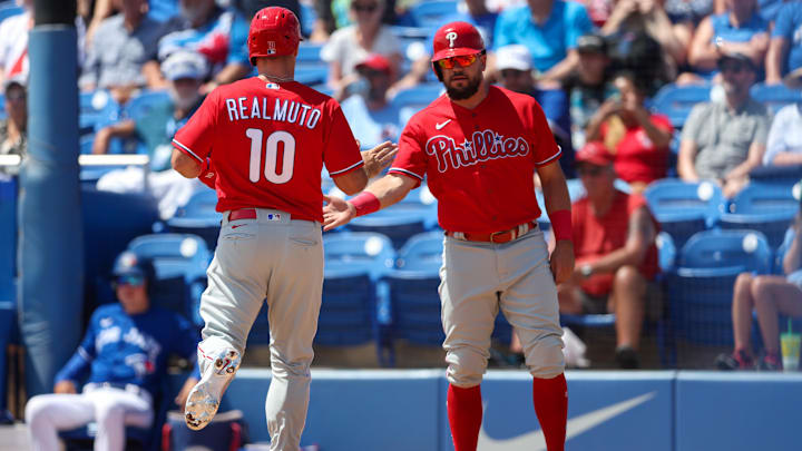 Mar 27, 2023; Dunedin, Florida, USA; Philadelphia Phillies catcher J.T. Realmuto (10) and left fielder Kyle Schwarber (12) score a run against the Toronto Blue Jays in the first inning during spring training at TD Ballpark. Mar 27, 2023; Dunedin, Florida, USA; Philadelphia Phillies catcher J.T. Realmuto (10) and left fielder Kyle Schwarber (12) score a run against the Toronto Blue Jays in the first inning during spring training at TD Ballpark.