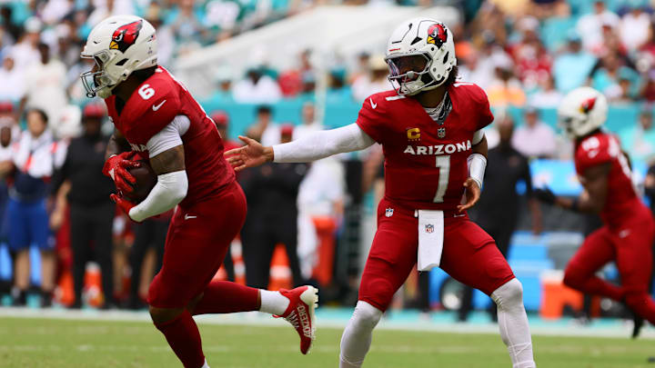 Oct 27, 2024; Miami Gardens, Florida, USA; Arizona Cardinals running back James Conner (6) takes a handoff from quarterback Kyler Murray (1) against the Miami Dolphins during the first quarter at Hard Rock Stadium. Mandatory Credit: Sam Navarro-Imagn Images