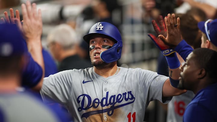 Sep 16, 2024; Atlanta, Georgia, USA; Los Angeles Dodgers shortstop Miguel Rojas (11) celebrates with teammates after scoring a run against the Atlanta Braves in the seventh inning at Truist Park. Sep 16, 2024; Atlanta, Georgia, USA; Los Angeles Dodgers shortstop Miguel Rojas (11) celebrates with teammates after scoring a run against the Atlanta Braves in the seventh inning at Truist Park.