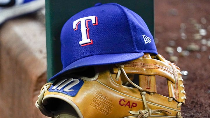 A Texas Rangers cap and baseball mitt.