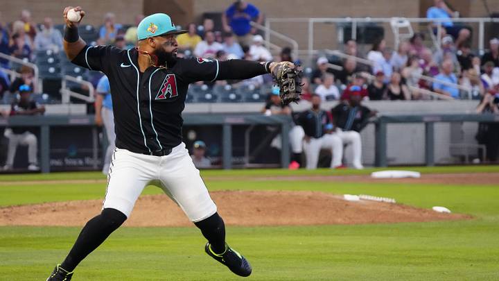 Diamondbacks first baseman Carlos Santana (41) throws out a Brewers runner at second base during a spring training game against the Brewers at Salt River Fields on March 20, 2026.