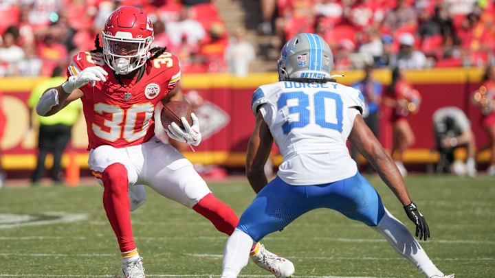 Aug 17, 2024; Kansas City, Missouri, USA; Kansas City Chiefs running back Keaontay Ingram (30) runs the ball as Detroit Lions cornerback Khalil Dorsey (30) defends during the game at GEHA Field at Arrowhead Stadium. Mandatory Credit: Denny Medley-Imagn Images