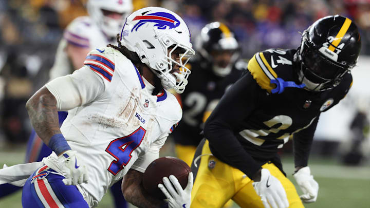 Buffalo Bills running back James Cook III (4) rushes as Pittsburgh Steelers cornerback Joey Porter Jr. (24) defends during the fourth quarter at Acrisure Stadium.