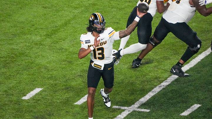 Sep 11, 2026; Lawrence, Kansas, USA; Missouri Tigers quarterback Austin Simmons (13) throws a pass against the Kansas Jayhawks during the first half of the game at David Booth Kansas Memorial Stadium. Mandatory Credit: Denny Medley-Imagn Images Sep 11, 2026; Lawrence, Kansas, USA; Missouri Tigers quarterback Austin Simmons (13) throws a pass against the Kansas Jayhawks during the first half of the game at David Booth Kansas Memorial Stadium. Mandatory Credit: Denny Medley-Imagn Images