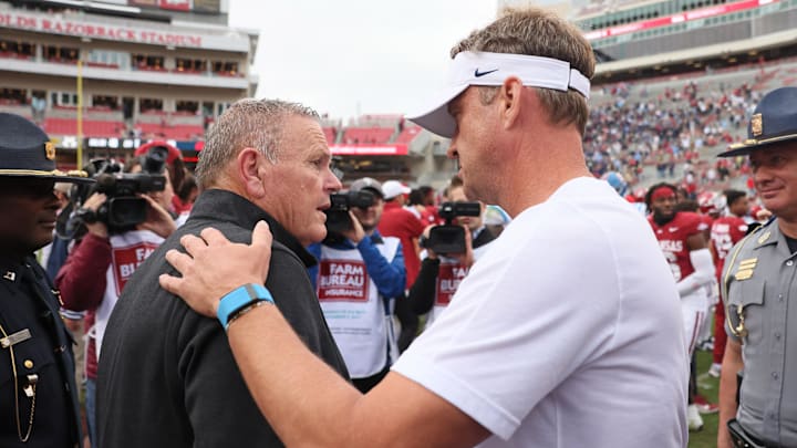 Nov 2, 2024; Fayetteville, Arkansas, USA; Arkansas Razorbacks head coach Sam Pittman shakes hands with Ole Miss Rebels head coach Lane Kiffin after the game at Donald W. Reynolds Razorback Stadium. Mississippi won 63-31. Mandatory Credit: Nelson Chenault-Imagn Images
