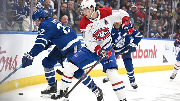 Montreal Canadiens forward Josh Anderson (17) battles for the puck against Toronto Maple Leafs defenseman Jake McCabe (22) in the second period at Scotiabank Arena.  Mandatory Credit: Dan Hamilton-Imagn Images