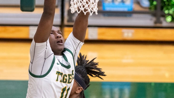 Indianapolis Crispus Attucks High School junior Dezmon Briscoe (11) attempts to score with a dunk during the second half of an IHSAA Class 4A Boys    Sectional basketball game, Wednesday, Feb. 28, 2024, at Lawrence North High School. Crispus Attucks won.