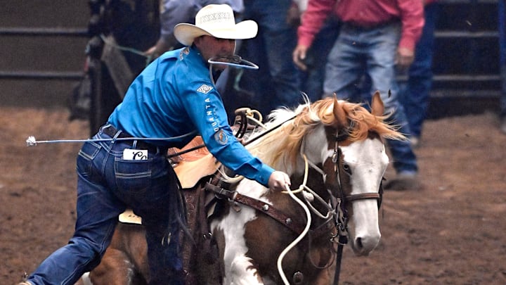 Riley Mason Webb of Denton, Texas leaps from his horse after roping a calf during Tie-Down Roping at the San Angelo Rodeo Saturday April 6, 2024. Riley Mason Webb of Denton, Texas leaps from his horse after roping a calf during Tie-Down Roping at the San Angelo Rodeo Saturday April 6, 2024.