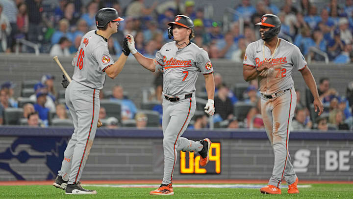 Aug 7, 2024; Toronto, Ontario, CAN; Baltimore Orioles second baseman Jackson Holliday (7) hits a two run home run and celebrates with  third baseman Coby Mayo (16) against the Toronto Blue Jays during the seventh inning at Rogers Centre. 