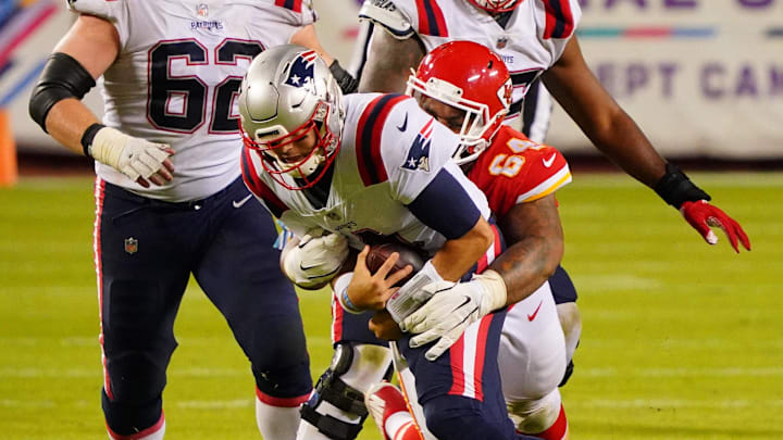 Oct 5, 2020; Kansas City, Missouri, USA; New England Patriots quarterback Jarrett Stidham (4) runs the ball against Kansas City Chiefs defensive tackle Mike Pennel (64) during the fourth quarter of a NFL game at Arrowhead Stadium. Mandatory Credit: Jay Biggerstaff-Imagn Images