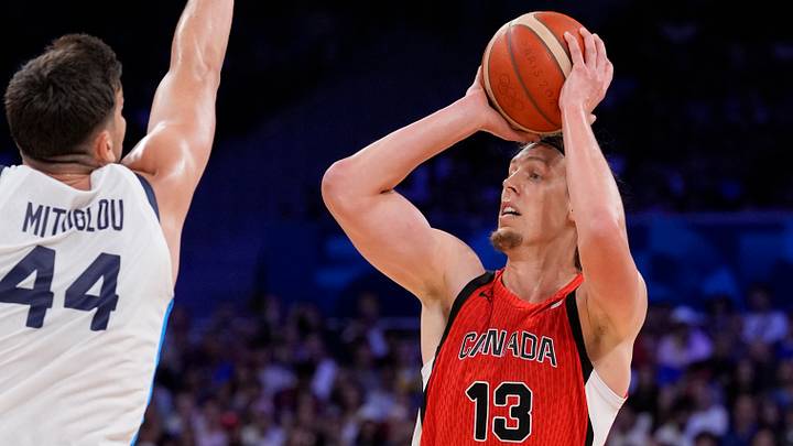 Jul 27, 2024; Villeneuve-d'Ascq, France; Canada forward Kelly Olynyk (13) shoots against Greece power forward Konstantinos Mitoglou (44) in the first half during the Paris 2024 Olympic Summer Games at Stade Pierre-Mauroy. Jul 27, 2024; Villeneuve-d'Ascq, France; Canada forward Kelly Olynyk (13) shoots against Greece power forward Konstantinos Mitoglou (44) in the first half during the Paris 2024 Olympic Summer Games at Stade Pierre-Mauroy.