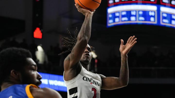 Bearcats Jizzle James (2) leaps with the ball during their game against the Morehead State Eagles at Fifth Third Arena on Friday November 8, 2024. Bearcats lead the game at halftime with a score of 37-19.