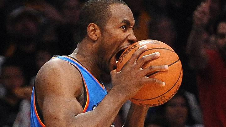 April 22, 2012;  Los Angeles, CA, USA; Oklahoma City Thunder power forward Serge Ibaka (9) takes a bite of the ball in frustration as actor Ashton Kutcher watches during the second half of the game against the Los Angeles Lakers at the Staples Center. Lakers won in double OT 114-106. Mandatory Credit: Jayne Kamin-Oncea-Imagn Images