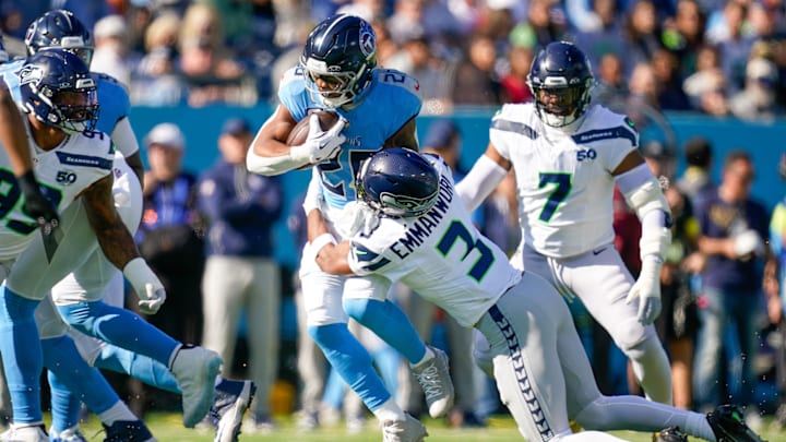 Tennessee Titans running back Tony Pollard (20) is tackled by Seattle Seahawks safety Nick Emmanwori (3) during the first quarter at Nissan Stadium in Nashville, Tenn., Sunday, Nov. 23, 2025.