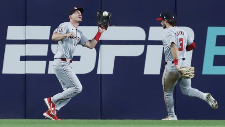 Sep 5, 2024; Pittsburgh, Pennsylvania, USA;  Washington Nationals center fielder Jacob Young (30) makes a catch for an out in front of right fielder Dylan Crews (3) against the Pittsburgh Pirates during the eighth inning at PNC Park. 