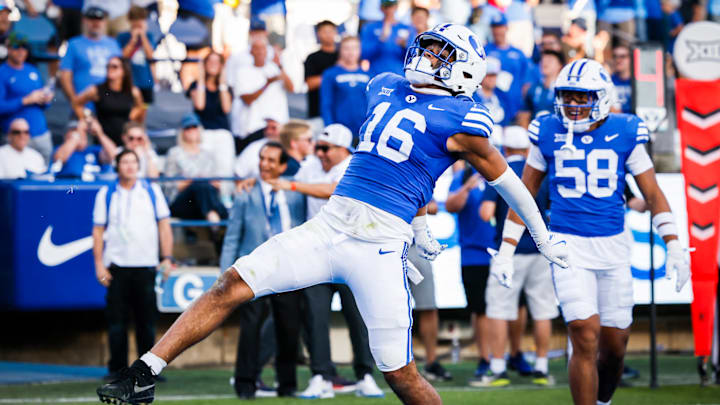 BYU linebacker Isaiah Glasker returns an interception for a touchdown against Arizona BYU linebacker Isaiah Glasker returns an interception for a touchdown against Arizona