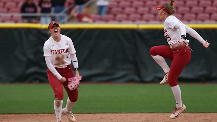 Stanford softball infielders celebrate a win at Stanford Stadium.