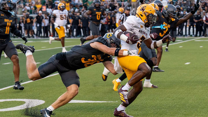 Redshirt sophomore safety Jacob Redding dives onto running back Raleek Brown for a tackle during Baylor football's 27-24 loss to Arizona State Saturday night at McLane Stadium. 