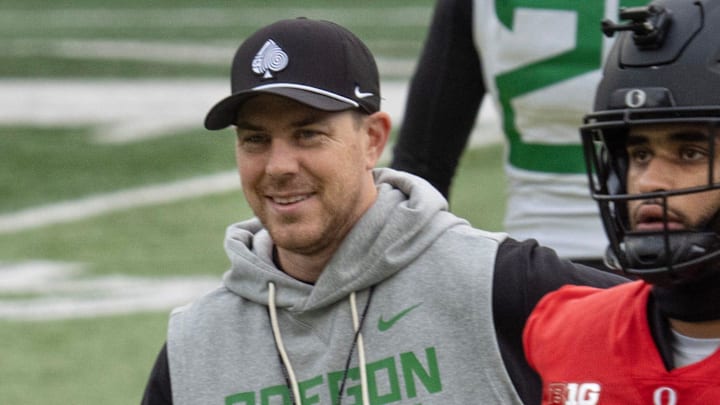Oregon Offensive Coordinator Will Stein leads a drill with quarterback Dante Moore at Autzen Stadium in Eugene Dec. 14, 2025 before the first-round CFP game against James Madison.