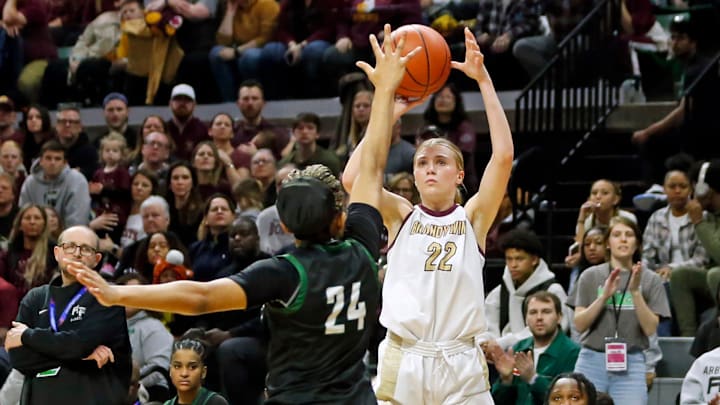 Brandywine junior Miley Young (22) shoots a '3' over Arbor Prep senior Stacy Utomi during the MHSAA Division 3 girls basketball state championship game Saturday, March 23, 2024, at the Breslin Center in East Lansing, Mich.