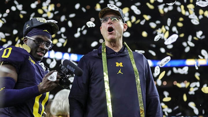 Michigan head coach Jim Harbaugh celebrates during the trophy presentation after the team's 34-13 win over the Washington Huskies to capture the CFP national championship.