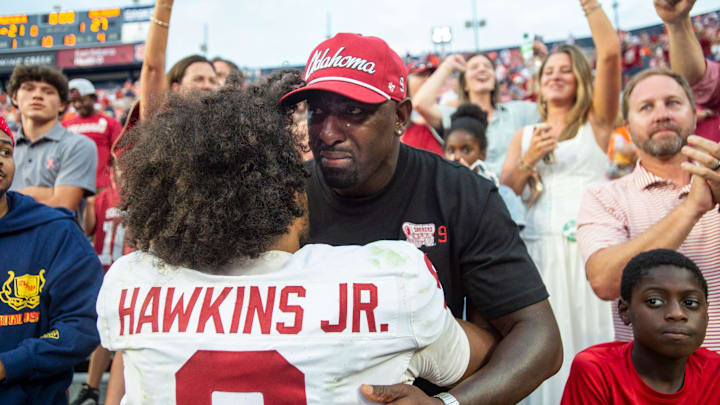 Oklahoma Sooners quarterback Michael Hawkins Jr. (9) hugs his dad, Michael Hawkins Sr., after the game as Auburn Tigers take on Oklahoma Sooners at Jordan-Hare Stadium in Auburn, Ala., on Saturday, Sept. 28, 2024. Oklahoma Sooners defeated Auburn Tigers 27-21.