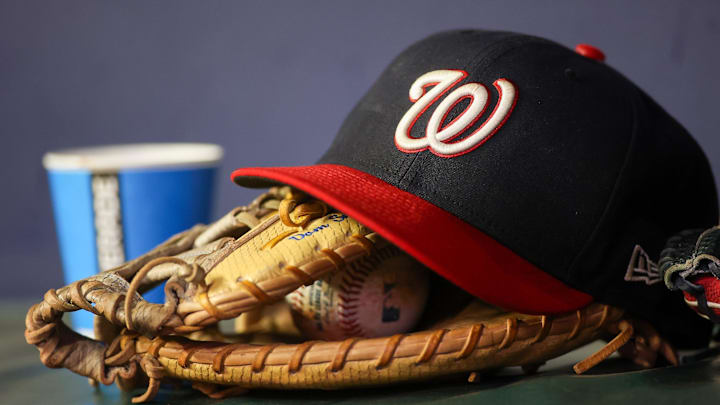 Sep 29, 2023; Atlanta, Georgia, USA; A detailed view of a Washington Nationals hat and glove on the bench against the Atlanta Braves in the third inning at Truist Park. Mandatory Credit: Brett Davis-Imagn Images