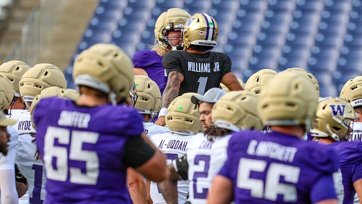 John Mills and Demond Williams Jr. chest bump each other. 