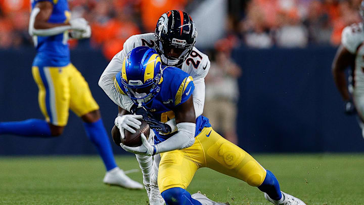 Aug 26, 2023; Denver, Colorado, USA; Los Angeles Rams wide receiver Tyler Johnson (14) is tackled by Denver Broncos cornerback Faion Hicks (29) in the first quarter at Empower Field at Mile High. Mandatory Credit: Isaiah J. Downing-Imagn Images