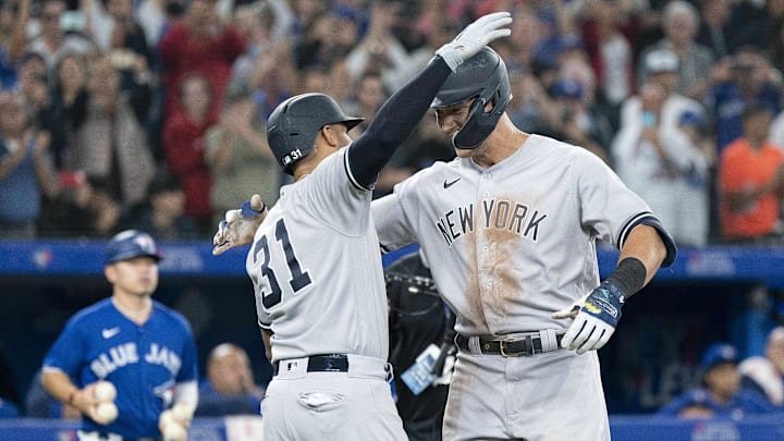 Sep 28, 2022; Toronto, Ontario, CAN; New York Yankees designated hitter Aaron Judge (99) celebrates with New York Yankees shortstop Oswald Peraza (91) after hitting his 61st home run scoring two runs against the Toronto Blue Jays during the seventh inning at Rogers Centre. Mandatory Credit: Nick Turchiaro-Imagn Images