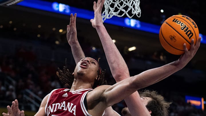 Indiana Hoosiers forward Malik Reneau (5) drives and makes the bucket Thursday, March 13, 2025, against Oregon Ducks center Nate Bittle (32) during the 2025 TIAA Big Ten Men’s Basketball Tournament at Gainbridge Fieldhouse in Indianapolis.