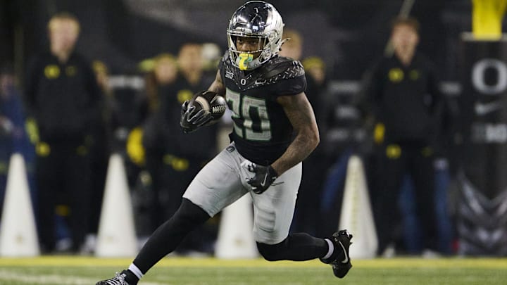 Nov 30, 2024; Eugene, Oregon, USA; Oregon Ducks running back Jordan James (20) carries the ball during the second half against the Washington Huskies at Autzen Stadium. Mandatory Credit: Troy Wayrynen-Imagn Images
