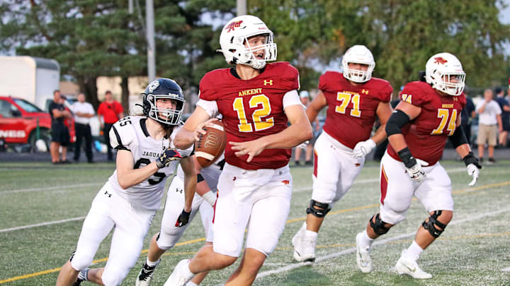 Ankeny High senior quarterback and Iowa State recruit JJ Kohl (12) throws on the run against Ankeny Centennial on Friday, September 2, 2022, at Ankeny Stadium.