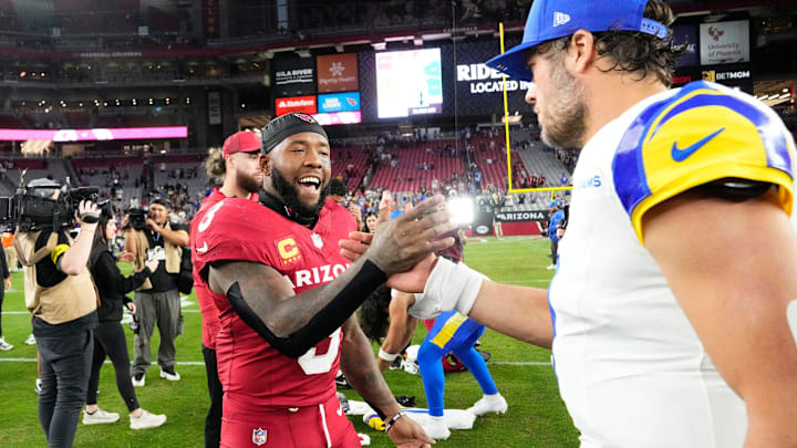 Former Husky Budda Baker greets Los Angeles Rams quarterback Matthew Stafford after their recent game. 