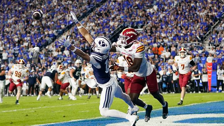 Oct 9, 2026; Provo, Utah, USA;  BYU Cougars wide reciever Reggie Frischknecht (18) dives for a ball while being defended by Iowa State Cyclones cornerback David Coffey (18) during the first half at LaVell Edwards Stadium.  Mandatory Credit: Aaron Baker-Imagn Images