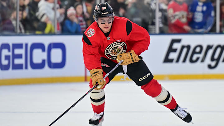 Dec 30, 2024; Chicago, Illinois, USA; Chicago Blackhawks center Connor Bedard (98) skates with the puck during a practice session prior to the Winter Classic ice hockey game against the St. Louis Blues at Wrigley Field. Mandatory Credit: Daniel Bartel-Imagn Images