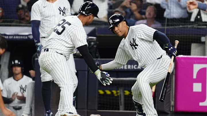 Sep 12, 2024; Bronx, New York, USA; New York Yankees right fielder Juan Soto (22) congratulated New York Yankees second baseman Gleyber Torres (25) for hitting a home run against the Boston Red Sox during the first inning at Yankee Stadium. Mandatory Credit: Gregory Fisher-Imagn Images