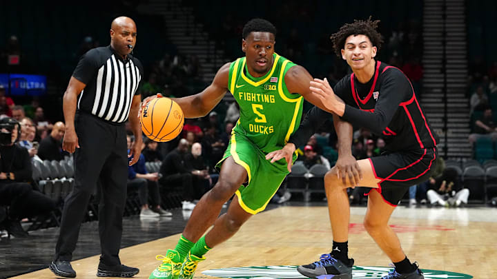 Nov 27, 2024; Las Vegas, Nevada, USA; Oregon Ducks guard TJ Bamba (5) dribbles against San Diego State Aztecs guard Miles Byrd (21) during the first half at MGM Grand Garden Arena. Mandatory Credit: Stephen R. Sylvanie-Imagn Images