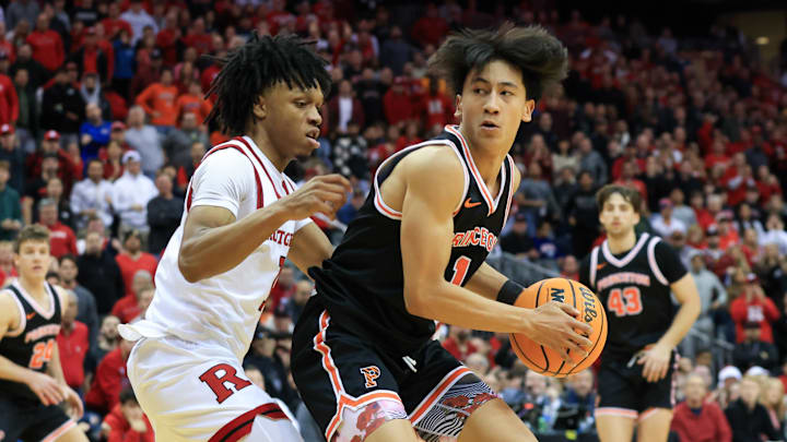 Dec 21, 2024; Newark, New Jersey, USA; Princeton Tigers guard Xaivian Lee (1) shoots the ball while being defended by Rutgers Scarlet Knights guard Jamichael Davis (1) during the second half at Prudential Center. Mandatory Credit: Tom Horak-Imagn Images