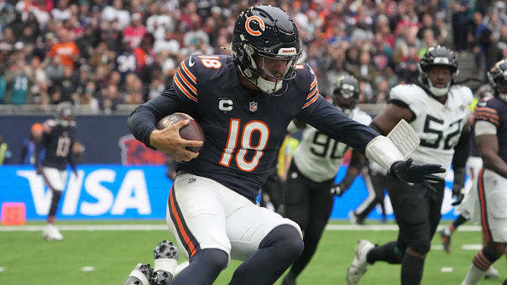 Caleb Williams breaks a tackle and tries for a first down on a run against Jacksonville in London.